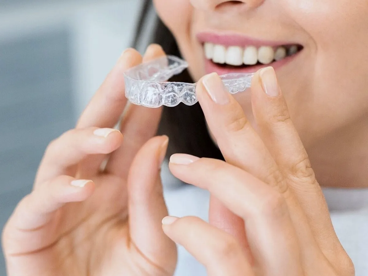 Person holding a clear aligner tray