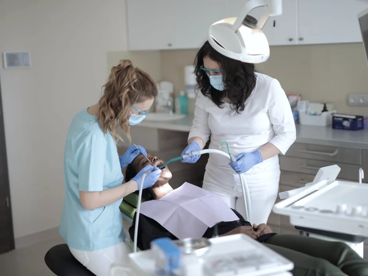 Dentist and assistant treating a patient
